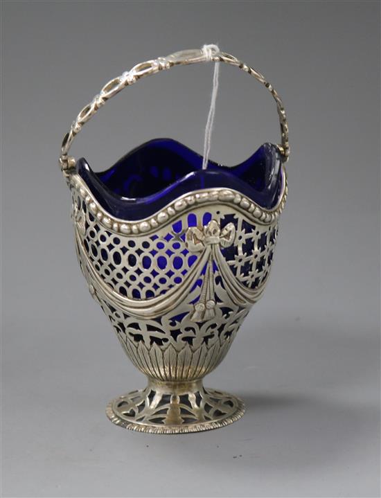 A late Victorian pierced silver sugar basket with blue glass liner, John Henry Rawlings, London, 1897, 11.6cm.